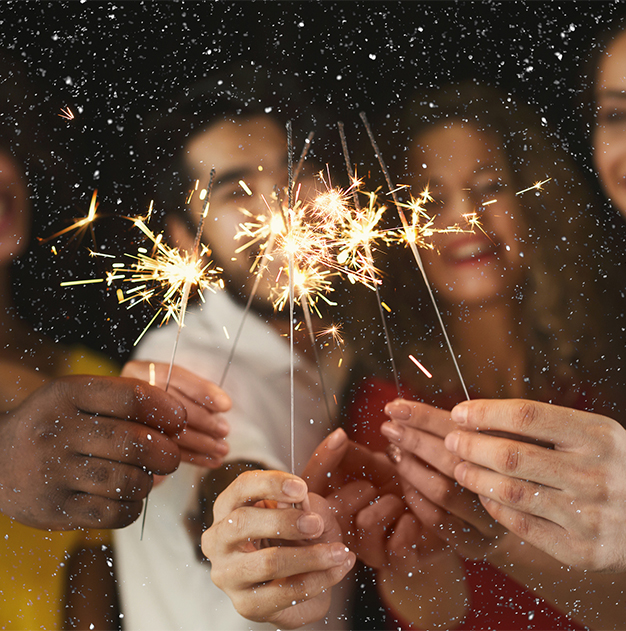 a group of people holding sparklers