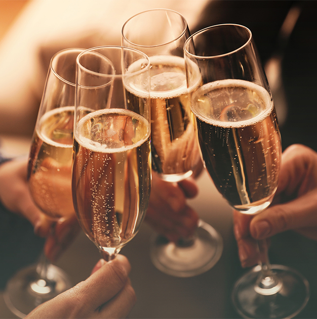 a group of people holding champagne glasses