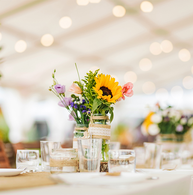 a table set with flowers and glasses
