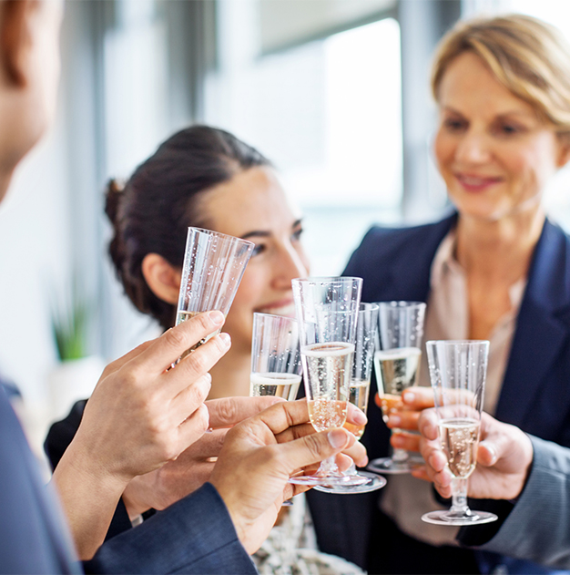 a group of people holding champagne glasses