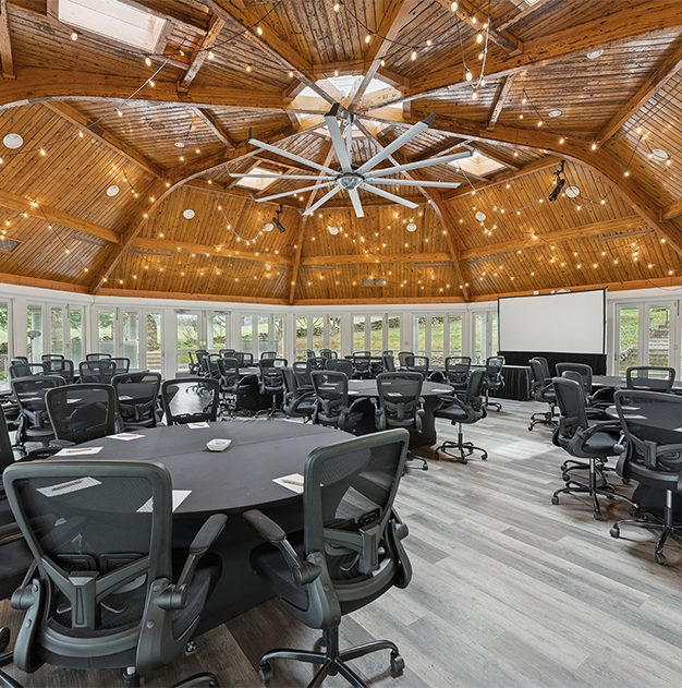 a room with a round table and chairs