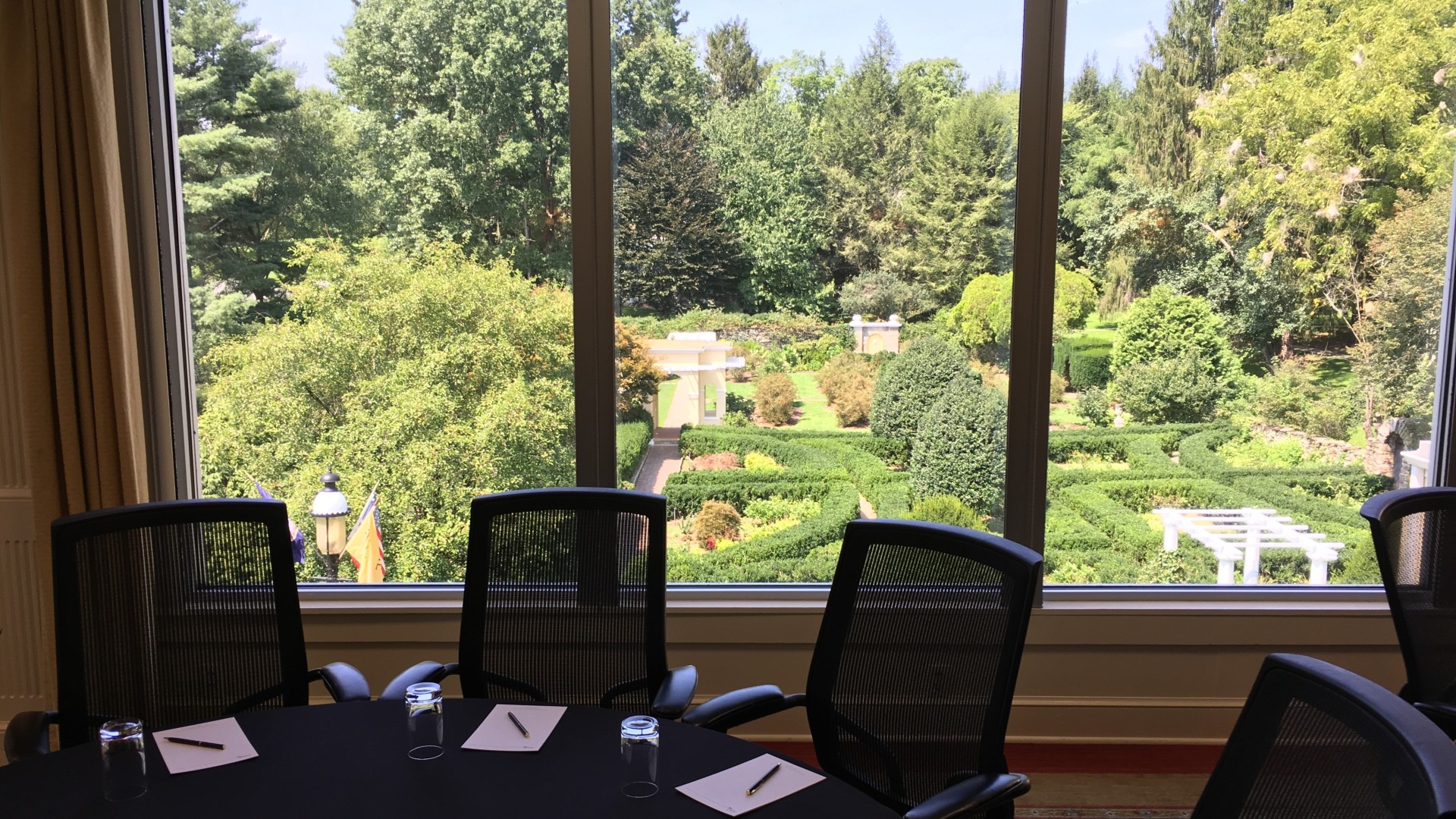 a table with chairs and a pen in front of a window