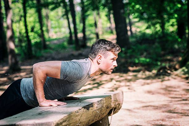 a man doing push ups on a bench Next