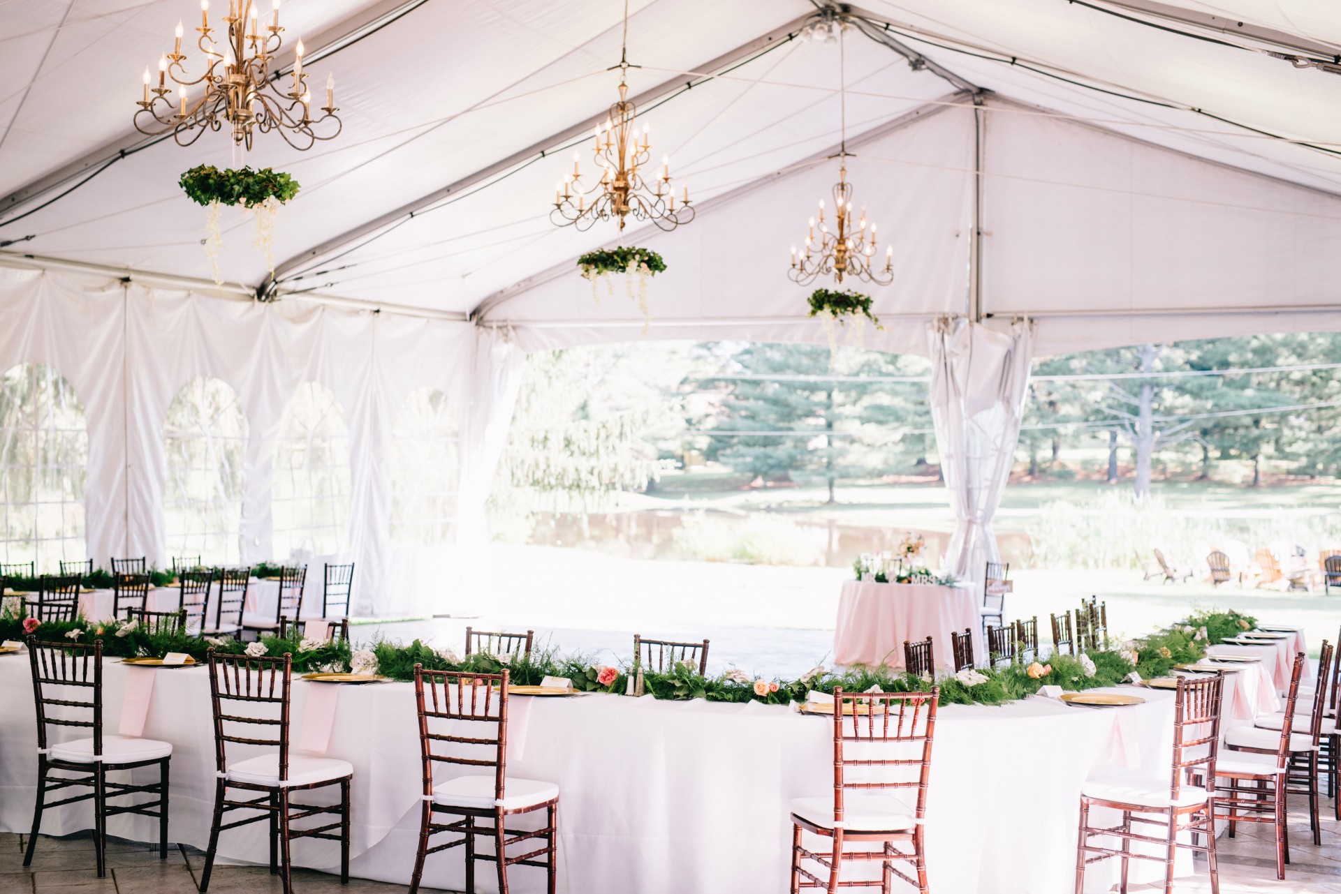 a white tent with tables and chairs
