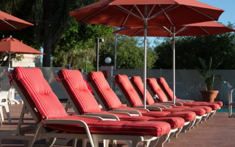 Airtel pool read cushion lounge chairs and umbrellas