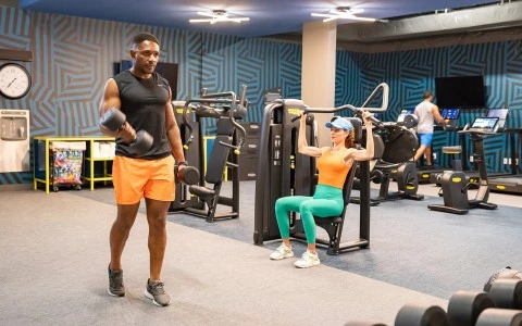 a man and woman working out in a gym