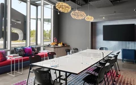 a meeting room with a table and chairs