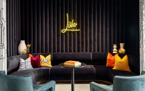 a couch with pillows and a table with books on it