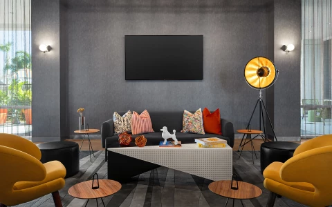 a living room with a black television on the wall