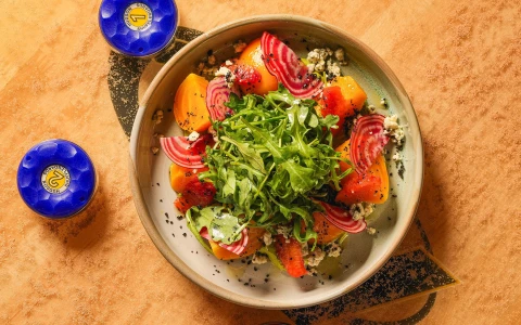 a bowl of salad with vegetables and cheese