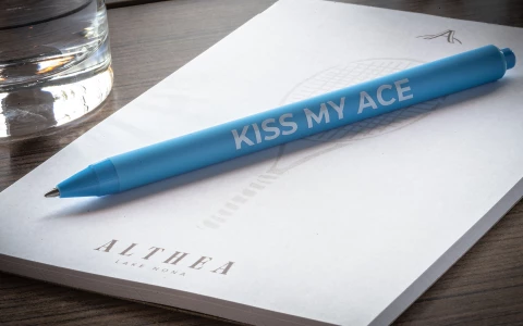 a blue pen on a white paper