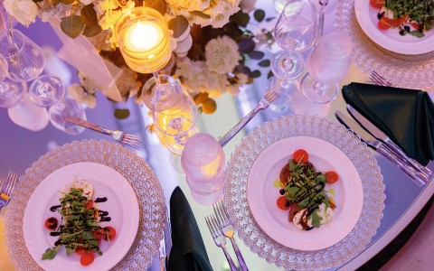 a table with plates of food and glasses