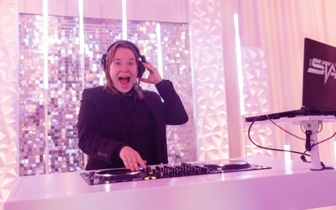 a woman wearing headphones and holding a record player