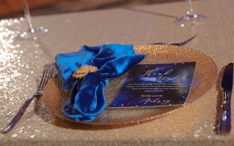 a plate with a napkin and a card on it