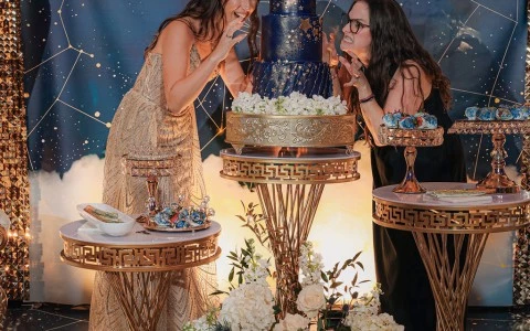 two women in front of a cake