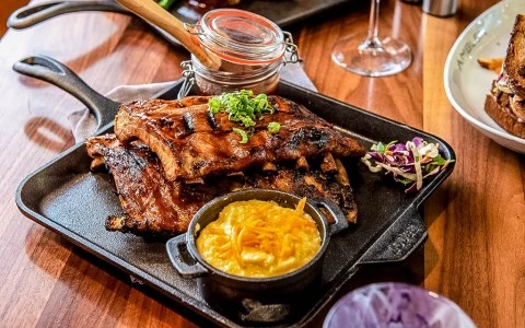 barbecue ribs on a cast iron plate with mac and cheese