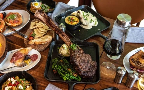 table filled with different plates of food and wine