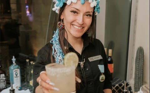 bartender passing off a margarita 