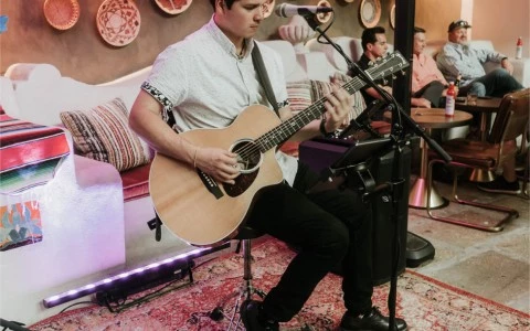 man sitting playing guitar