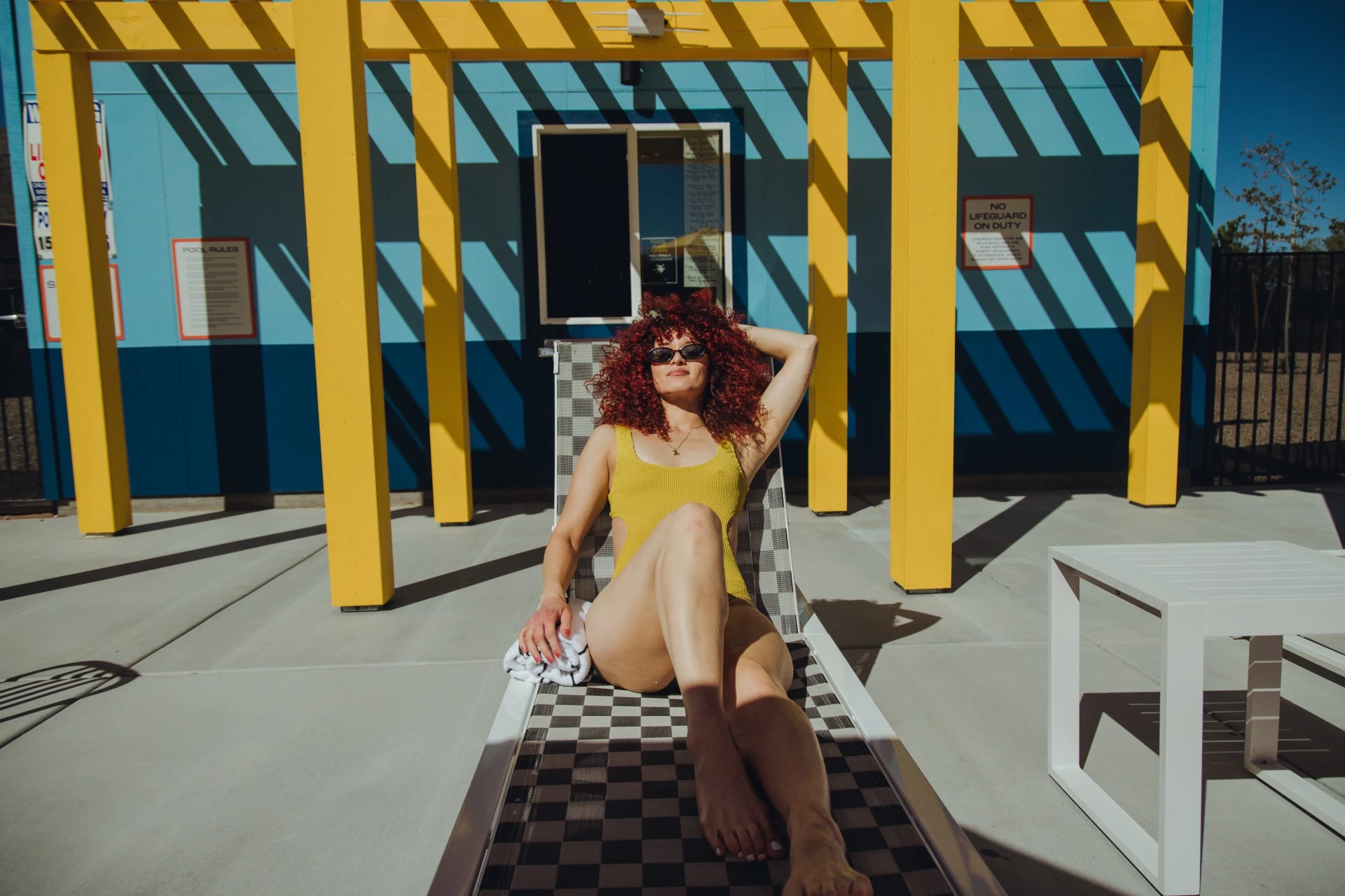 a woman sitting on a deck chair