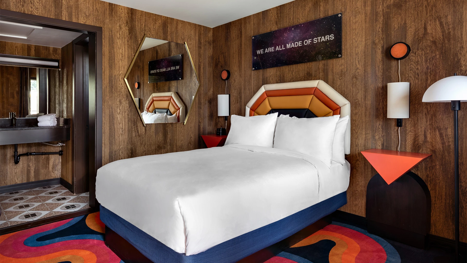 a bed with a mirror above it