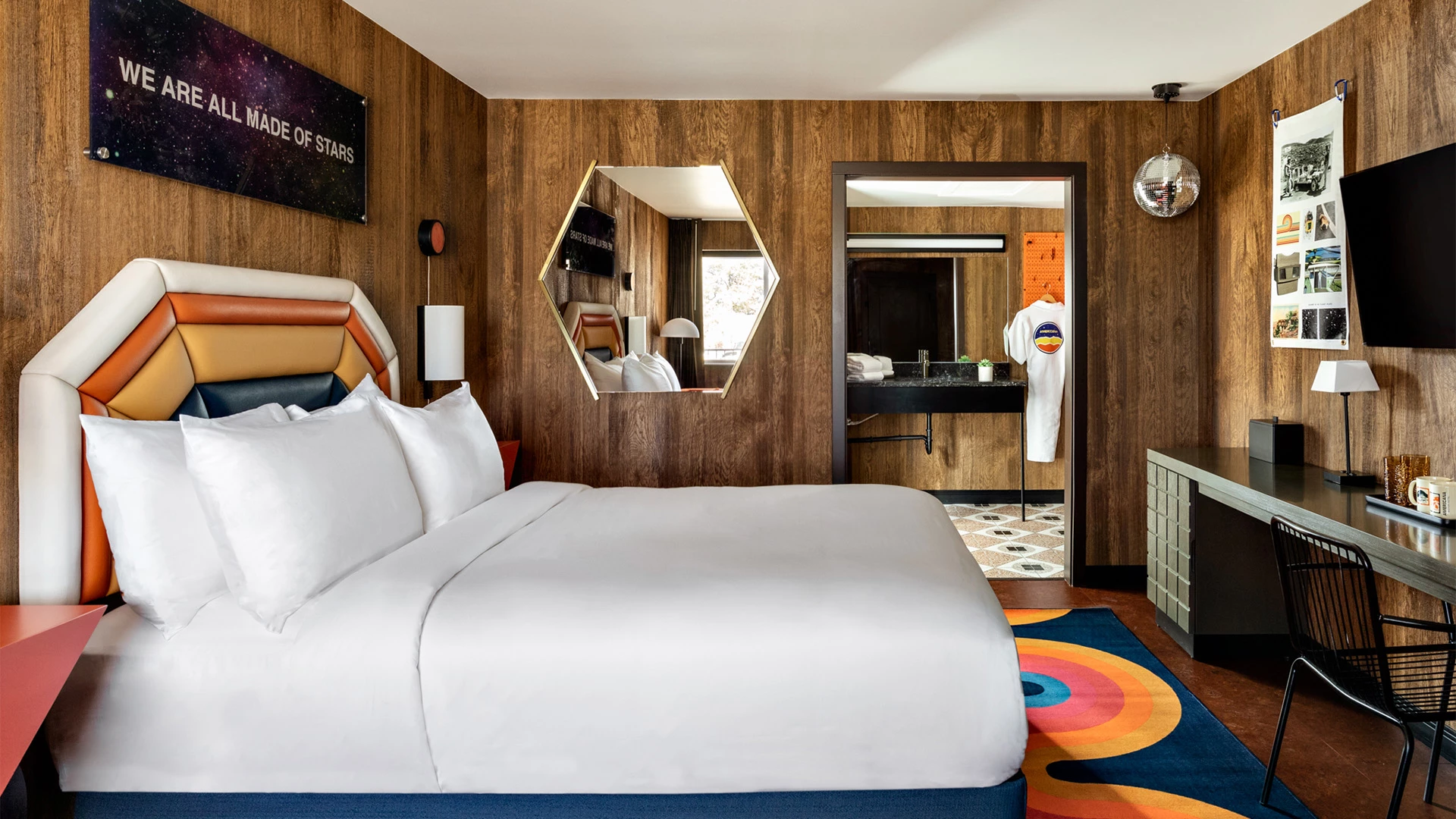 a bedroom with a bed and a desk