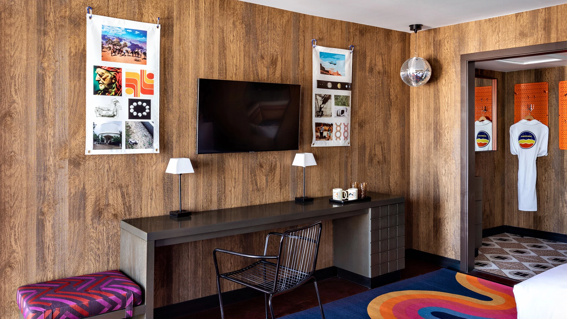 a room with a desk and a television