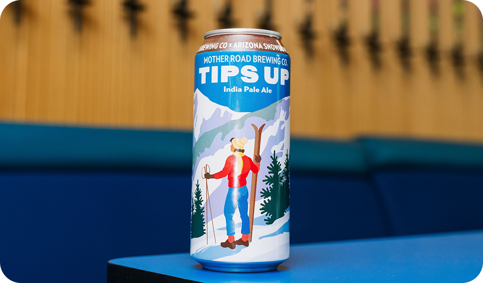 a can of beer on a blue surface