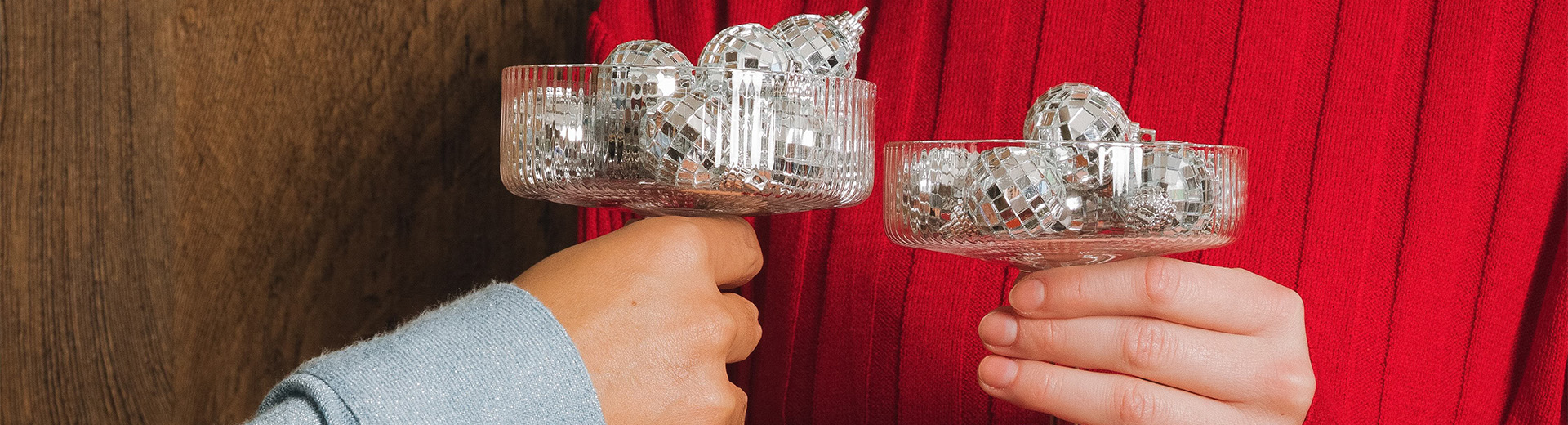 a person holding a bowl of disco balls