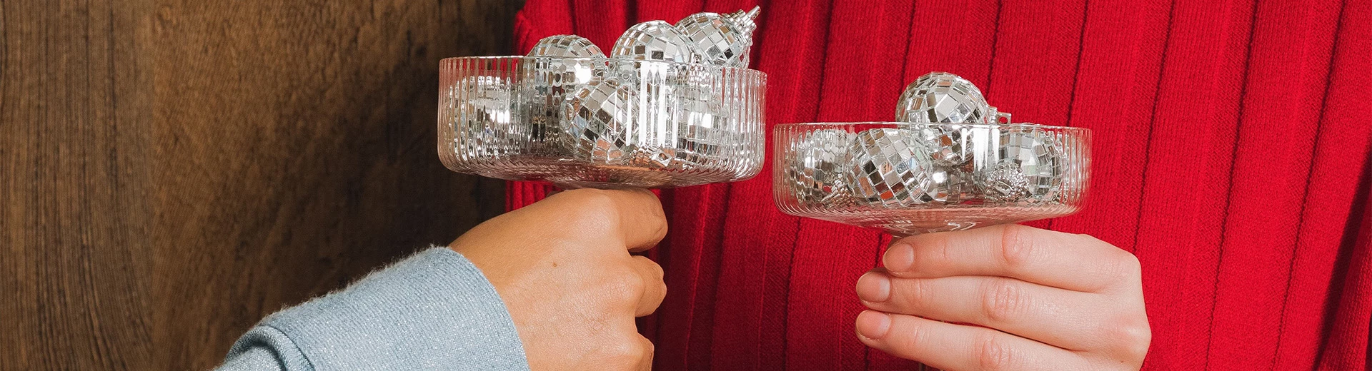 a person holding a bowl of disco balls