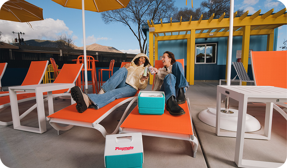 two women sitting on lounge chairs
