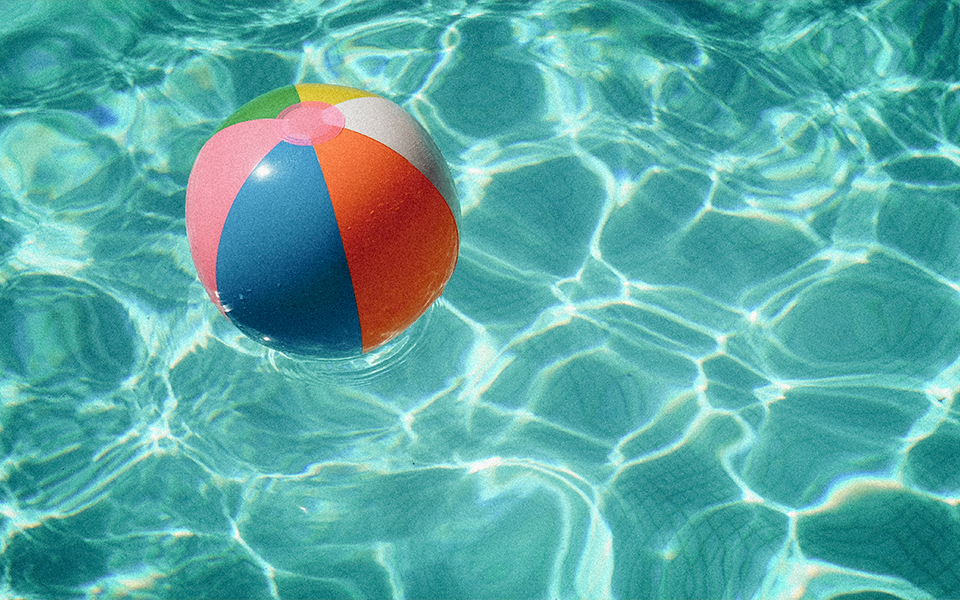 a colorful beach ball floating in a pool