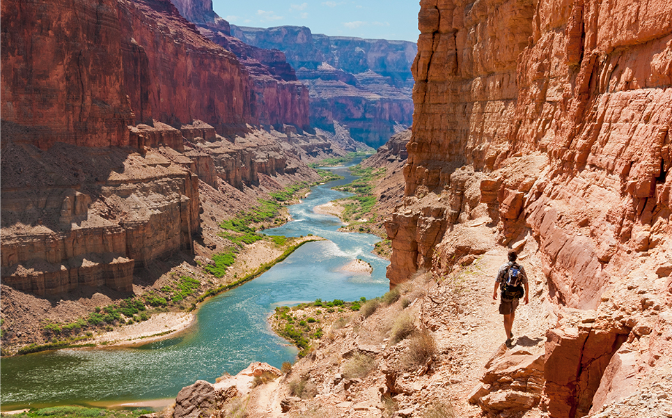 a person walking on a rocky cliff