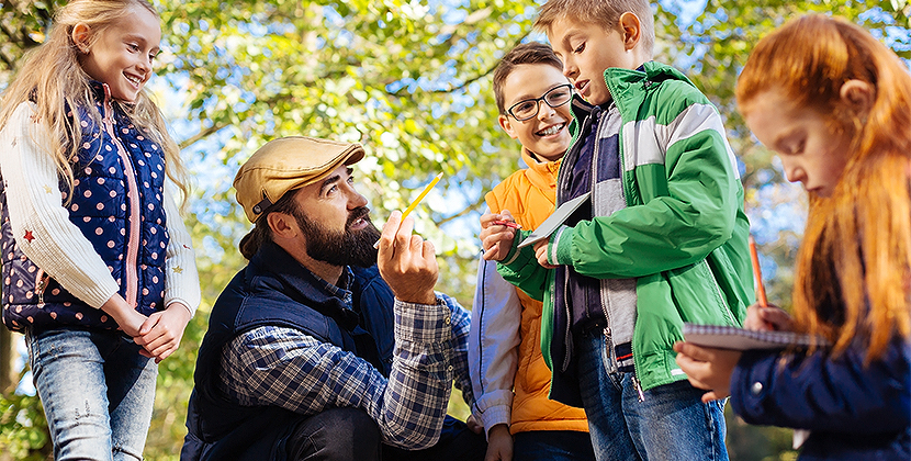 a man and two boys outside