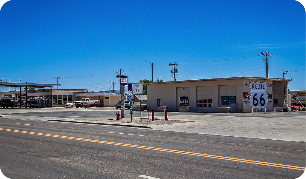 a street with a building and a parking lot