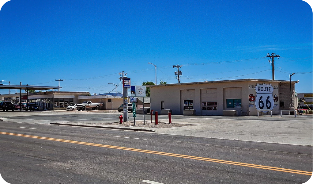 a street with a building and a parking lot