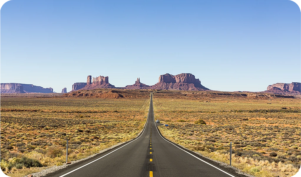 a long straight road through a desert