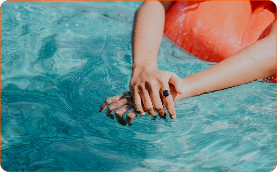a person's hand on a pool