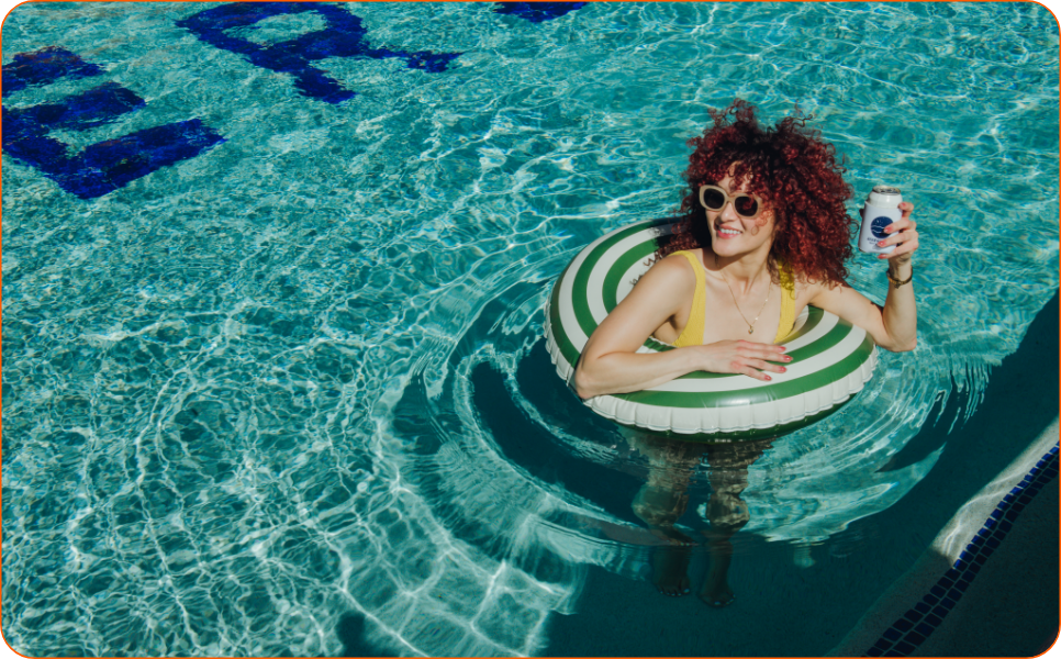 a woman in a pool with a float