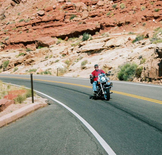 a man riding a motorcycle on a road