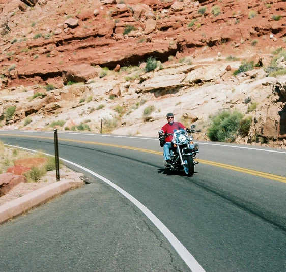 a man riding a motorcycle on a road