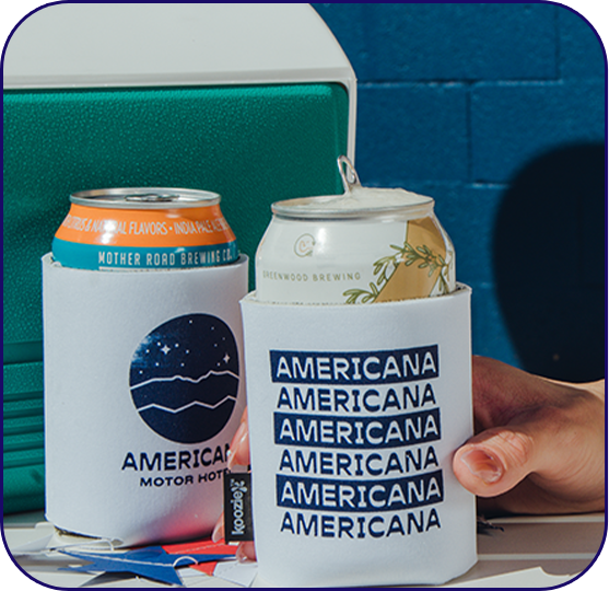 a hand holding a can next to a beverage