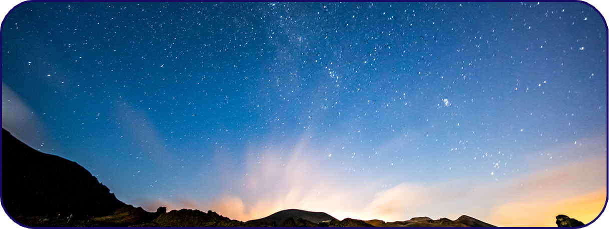 a starry sky over a mountain
