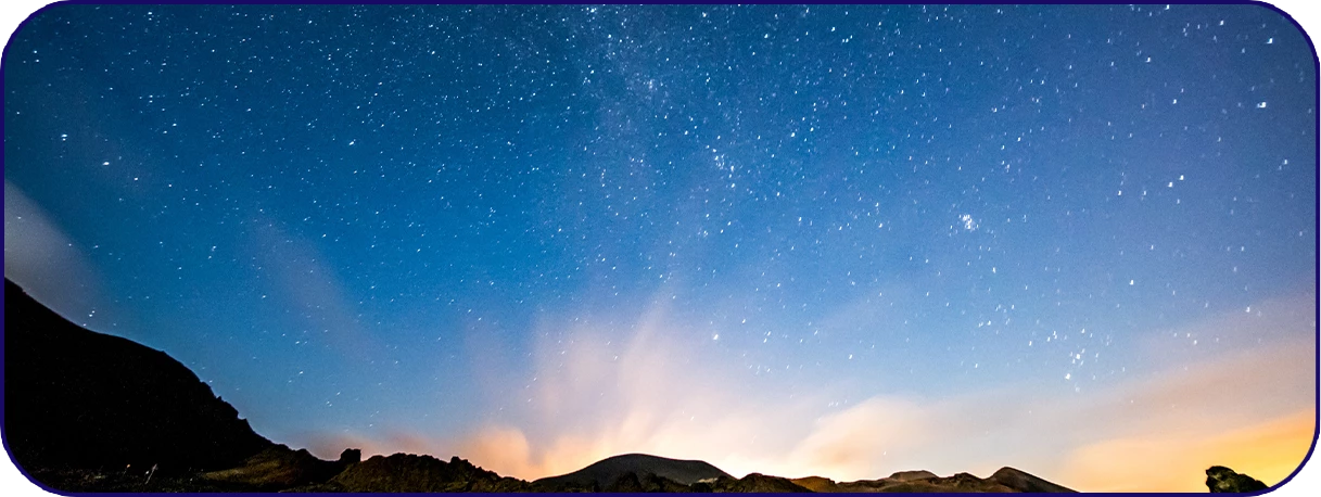 a starry sky over a mountain