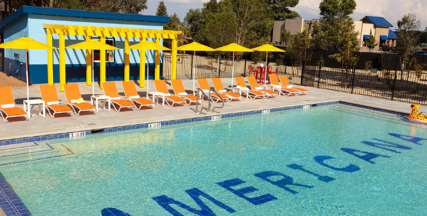 a pool with chairs and umbrellas