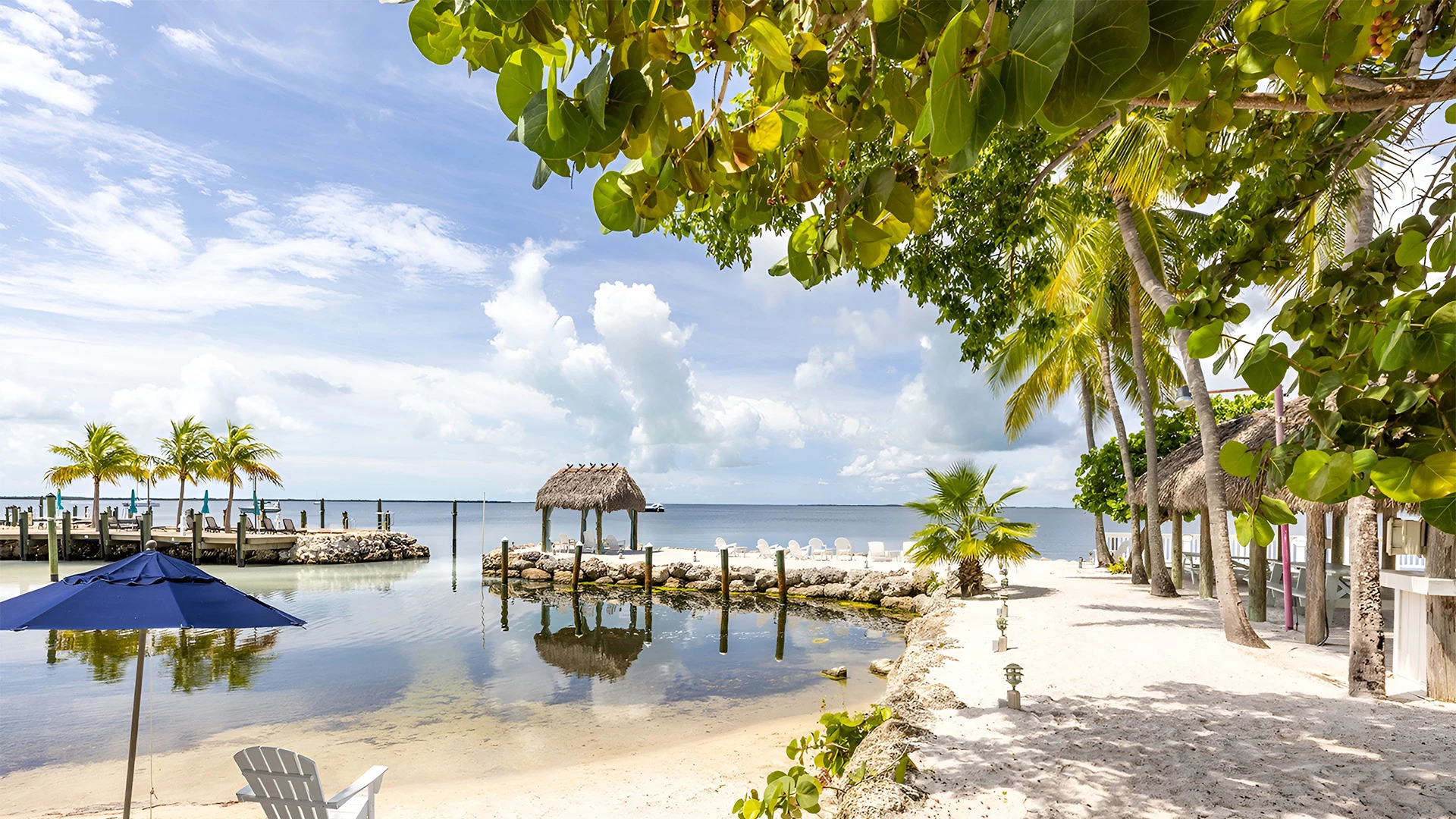 a beach with a dock and a hut