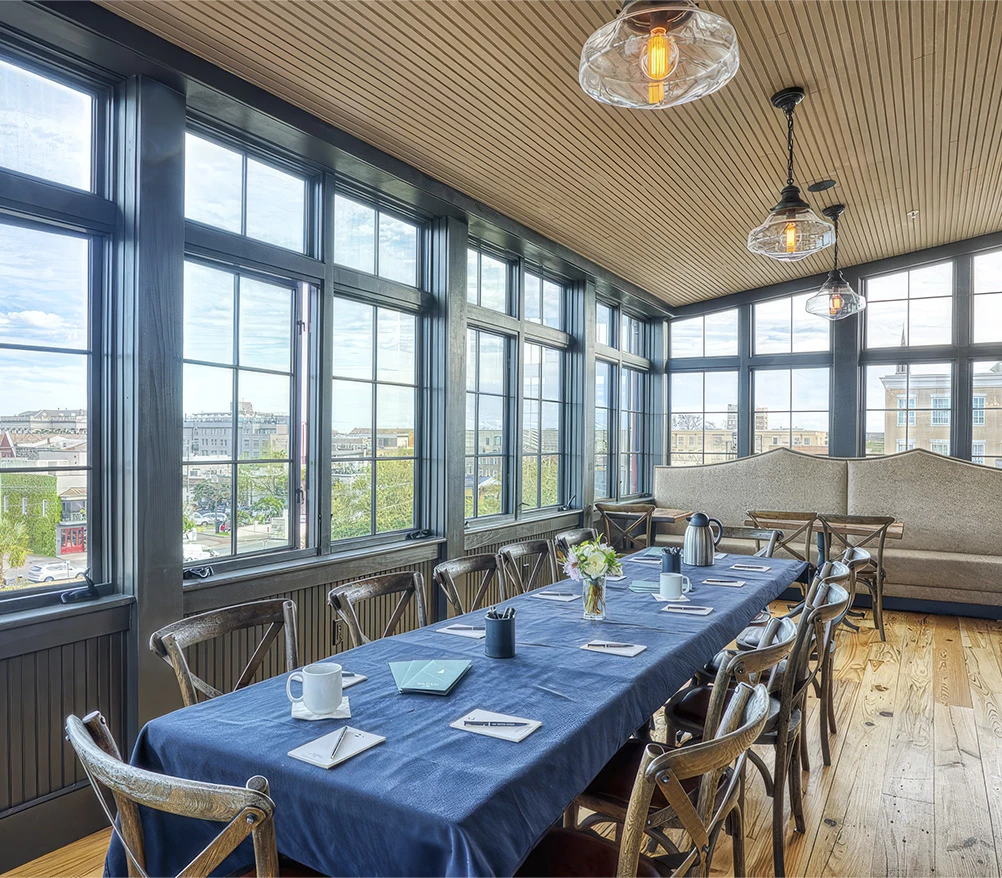 a room with a table and chairs and a blue tablecloth