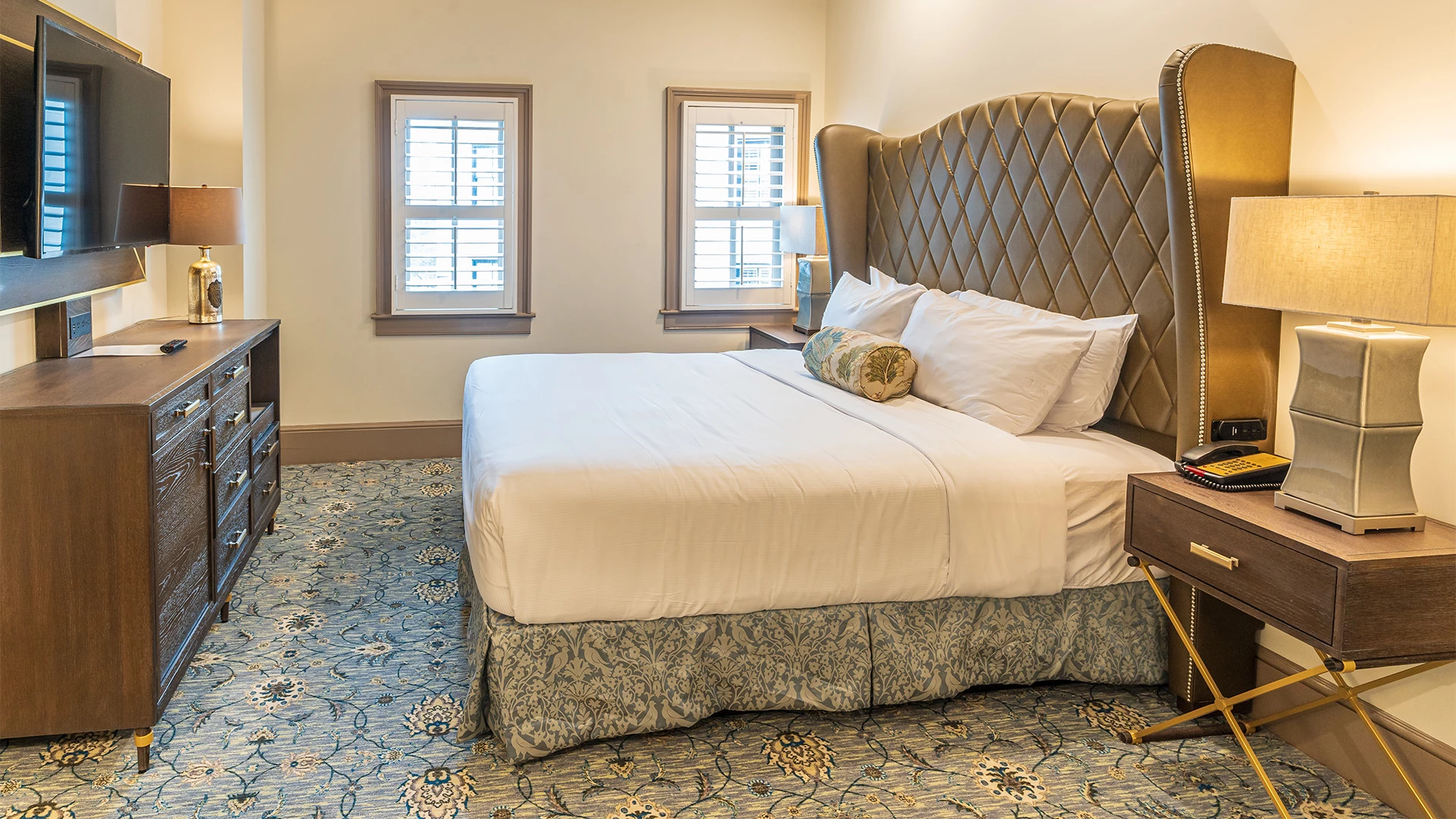 a bed with pillows and a lamp in a room