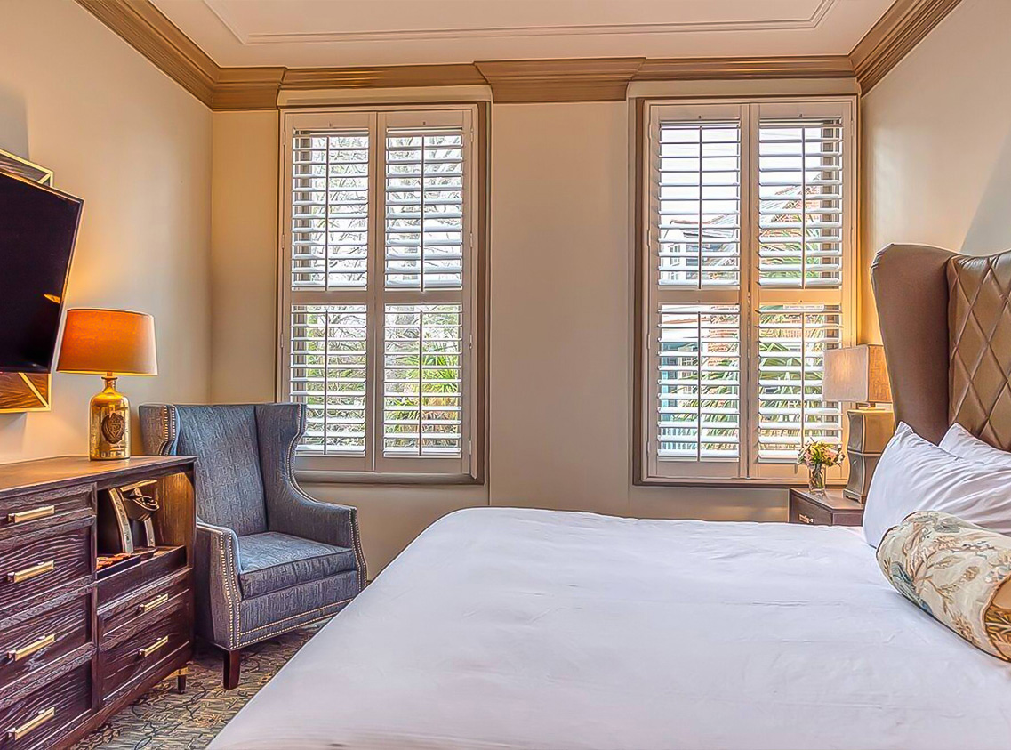 a bedroom with a bed and a chair