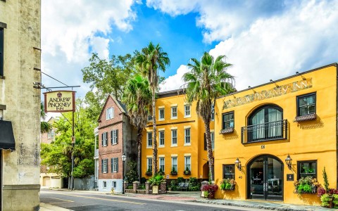 two yellow buildings with the andrew pinckney inn sign